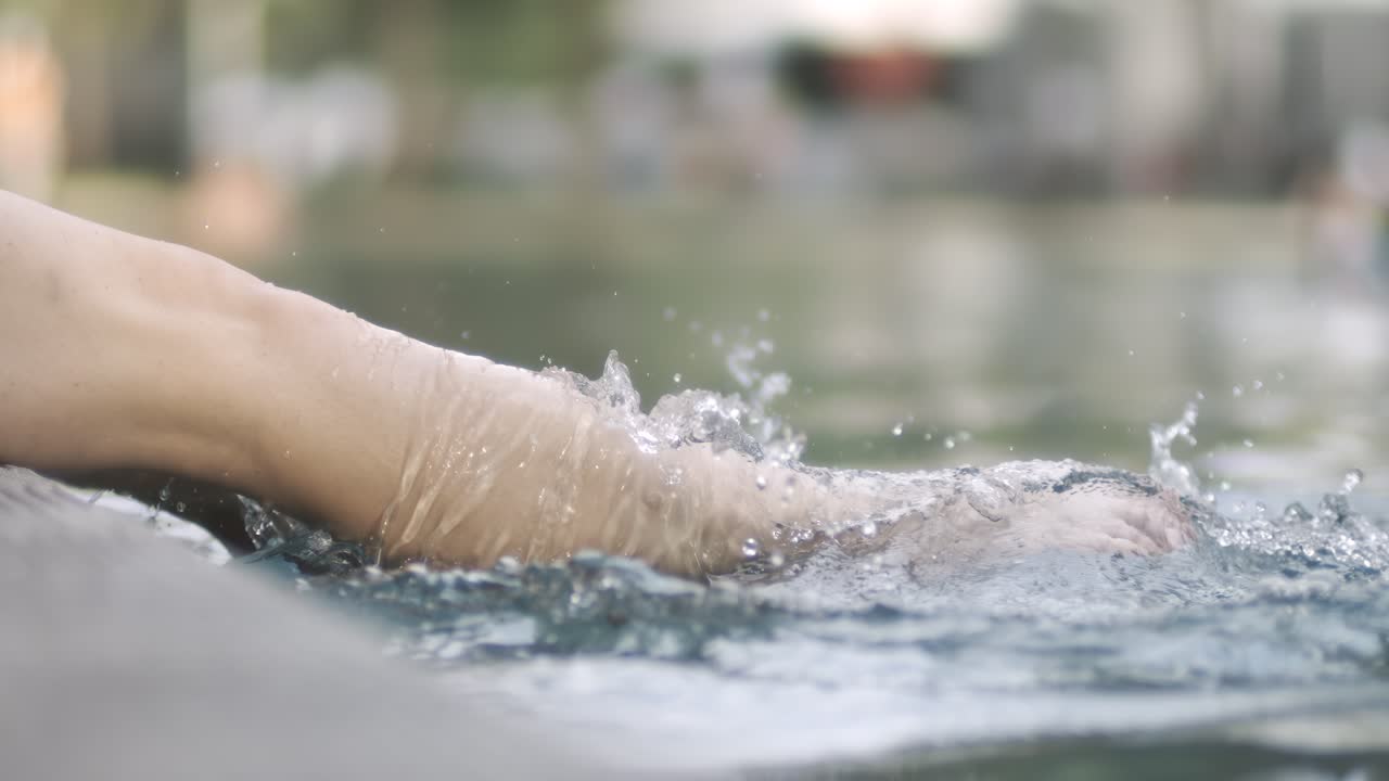 Woman legs splashing in the pool. Shot on super slow motion camera 1000 fps