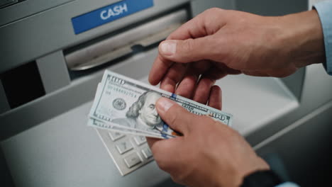 person withdrawing cash from an atm