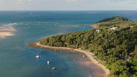 flying towards agnes waters with vast green forest and beaches, australia, aerial