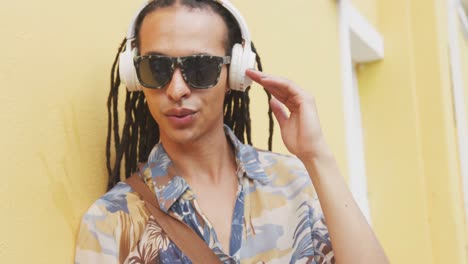 Mixed-race-man-listening-to-music-with-headphone