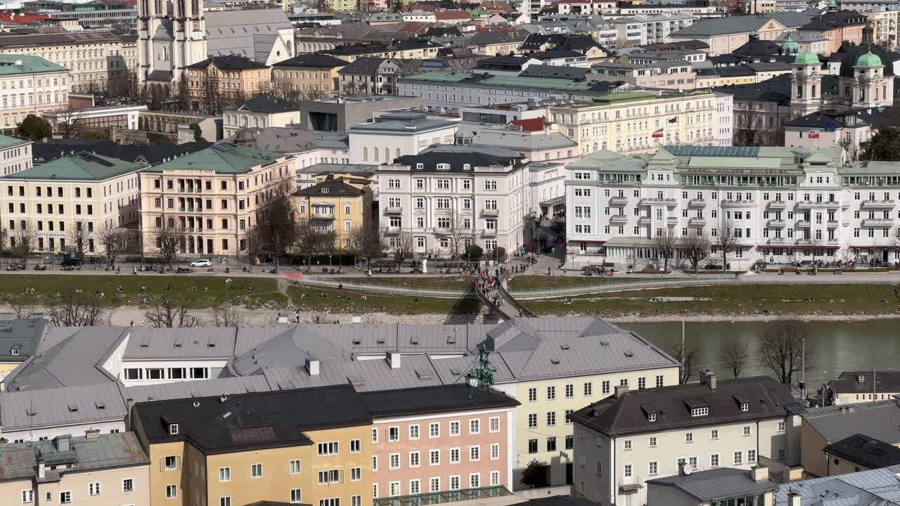 Cityscape of Salzburg with People Crossing the Salzach River Bridge