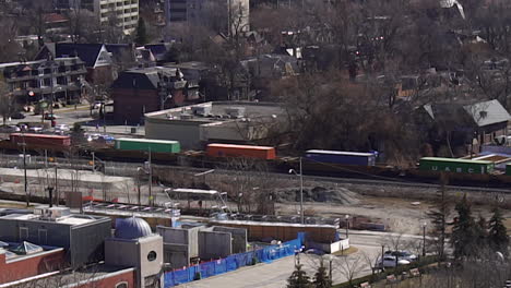 wide-shot-of-cargo-train-going-through-non--descript-city-in-the-day-morning