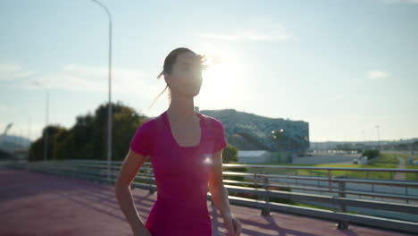 woman running on a bridge in the city