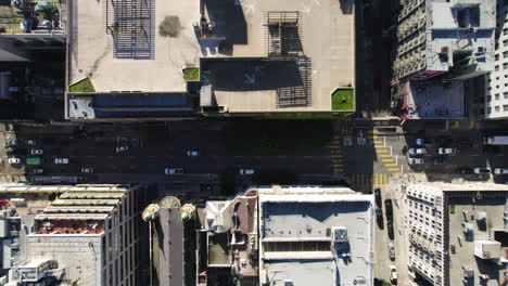 San-Francisco-USA,-Top-Down-Aerial-View-of-Street-Traffic-and-Buildings-Rooftops-Crossroads-of-Bush-and-Stockton-Street,-Birds-Eye-Drone-Shot