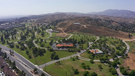 Wide-reverse-pullback-panning-aerial-shot-of-an-expansive-mortuary-in-California