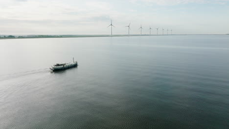 aerial view of the luxemotor dutch boat traveling from the harbor of urk in the province of flevoland. holland