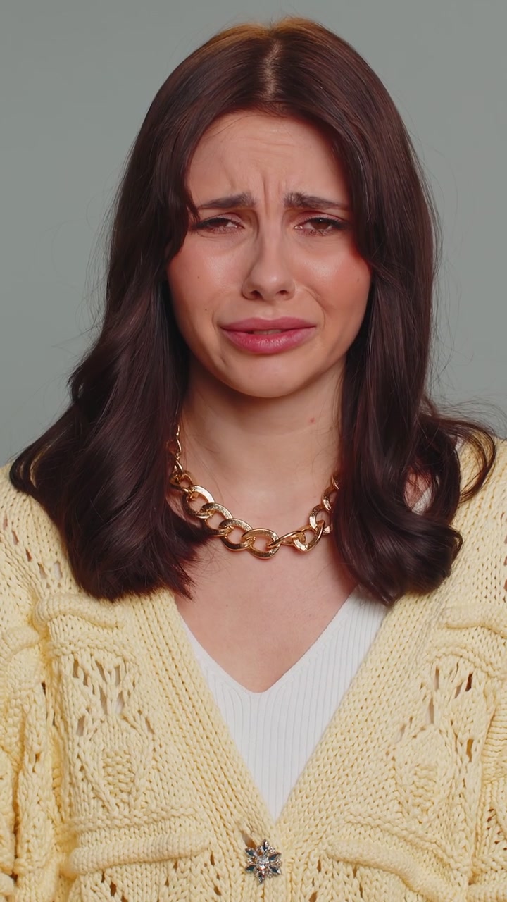 Upset disappointed woman wipes tears and cries from despair being sad because of unfair things