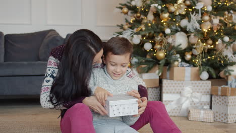 mother and son opening christmas gift