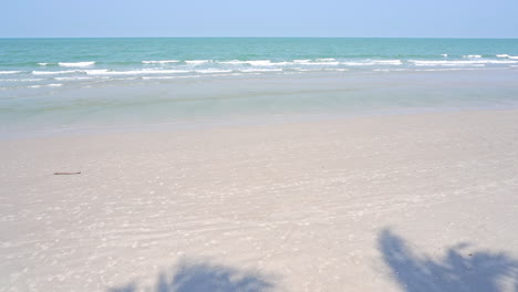 slow motion of waves rolling up on a white sandy beach