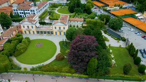 4k aerial drone video of the beautiful lakeside gardens of brivio serena villa on lake como, italy in the summer
