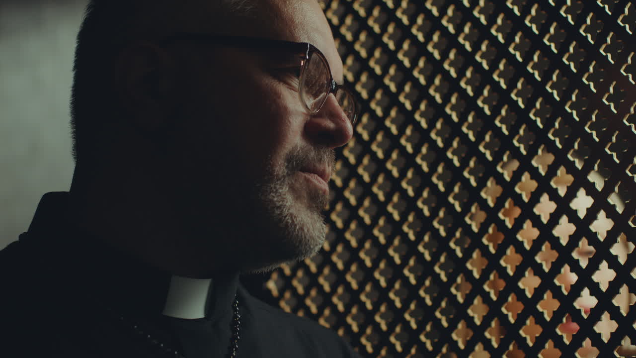 Catholic Priest Giving Advice to Penitent during Confession