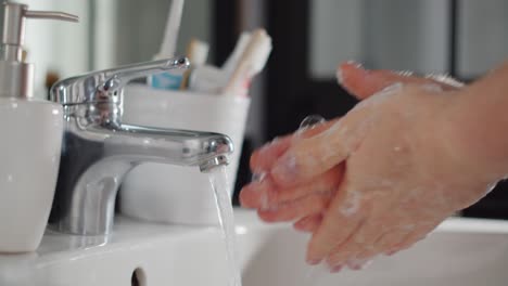 static shot of man washing his hands