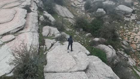 Aerial-views-on-the-mountain-with-fog-flying-over-a-person