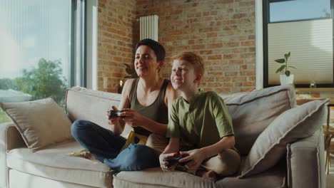 mother and son playing video games at home