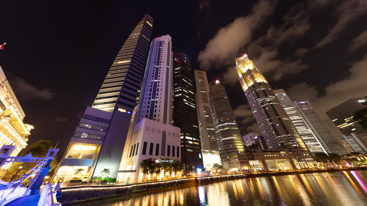 SINGAPORE - 5 MARCH 2025 : timelapse of the singapore central business district skyline reflected in the river at night