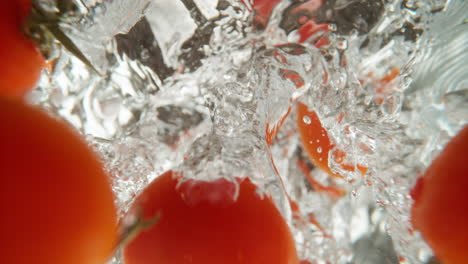 tomatoes splashing in water