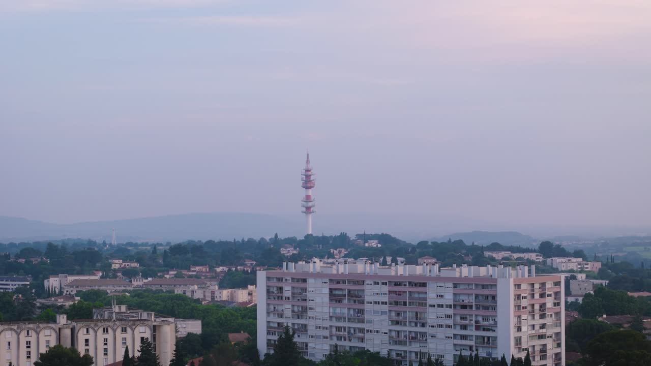 Aerial shot of a red transmission tower near the Celleneuve District in France