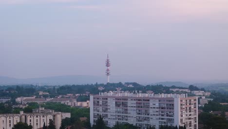 aerial shot of a red transmission tower near the celleneuve district in france