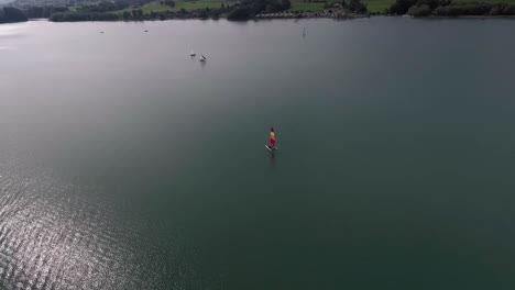 aerial flight around a sailboat, lake gruyère, switzerland