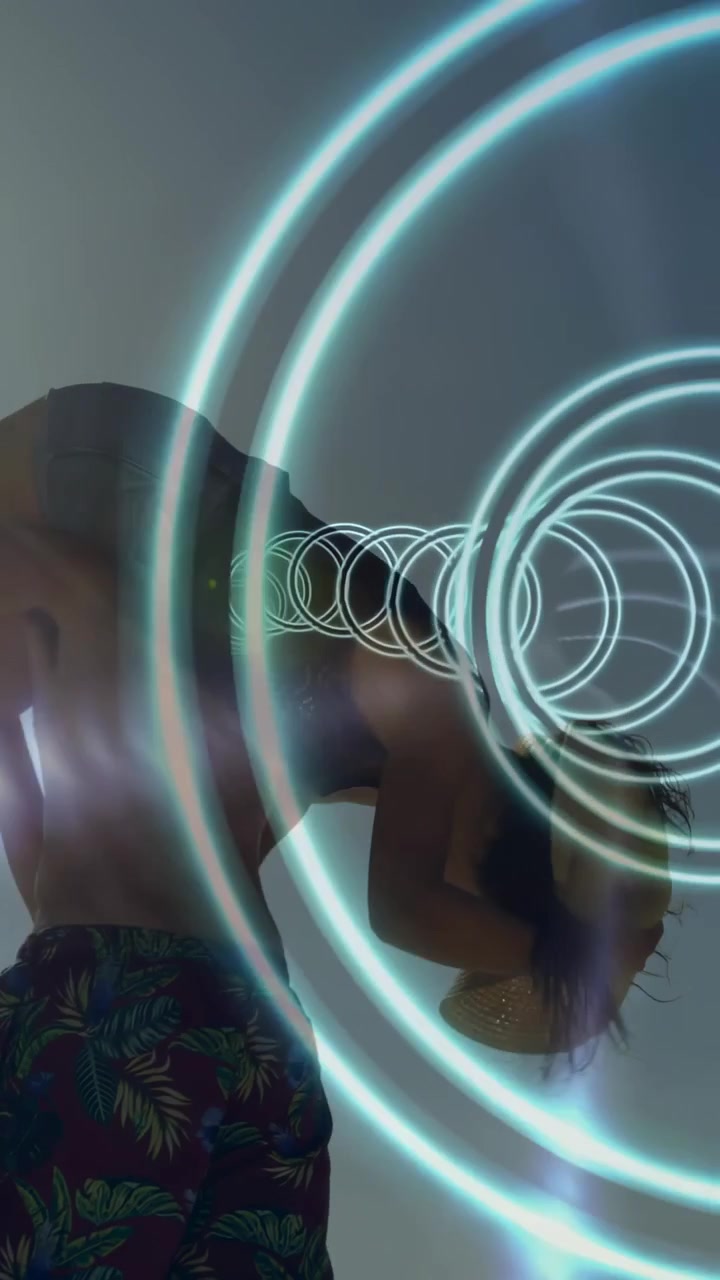 Vertical video: Rings aligning over heads sparking lift silhouetted pair lifting and reaching rings