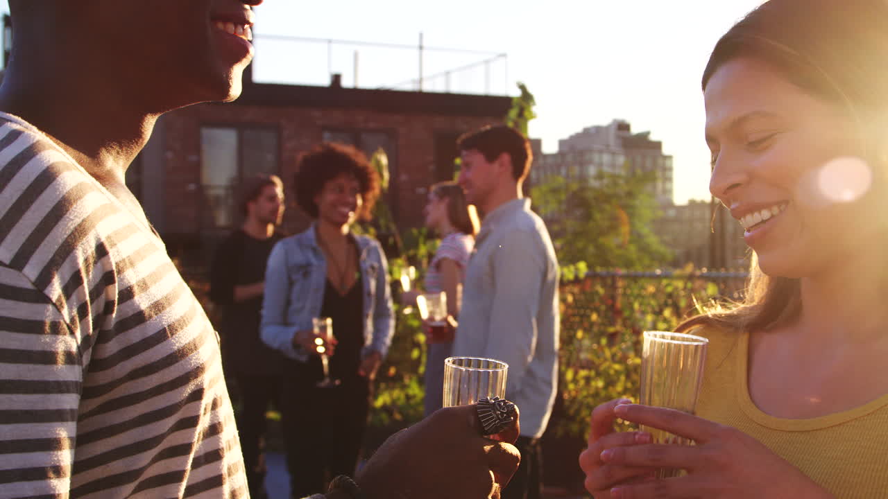 Couples talking at a rooftop party in Brooklyn