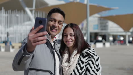 Smiling-young-couple-posing-for-selfie