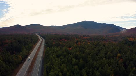 aerial flyover of cars travelling through franconia notch state park on interstate 93