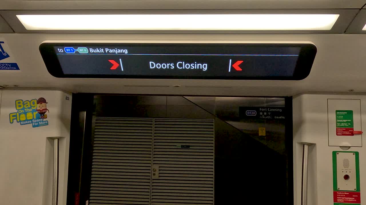 Automatic subway doors close at Singapore MRT station, bright interior lighting, static camera, commuters visible