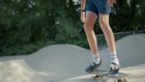 skateboarder jumping out of bowl at skatepark