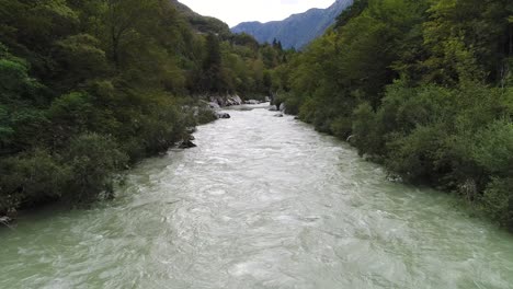 aerial drone shot of a river near the surface in slovenia, 4k uhd