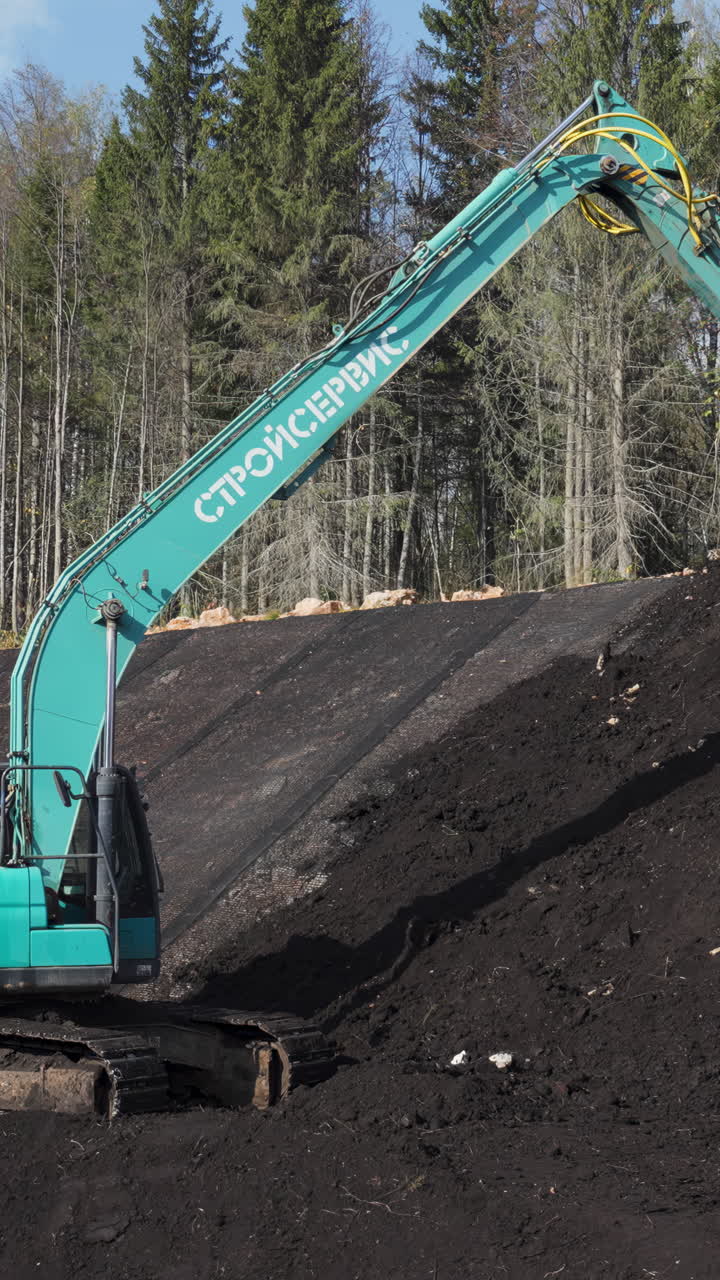 Excavator working on a construction site or landfill with earth