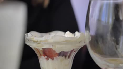 Slow-motion-spoon-scooping-delicious-creamy-ice-cream-whipped-cream-desert