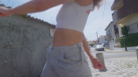 woman walking down a sunny street