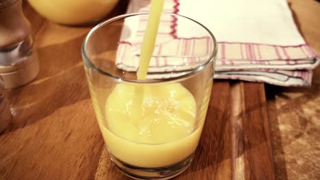 orange juice pouring into a glass, the morning breakfast. slow motion with rotation tracking shot.