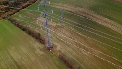 aerial view of transmission lattice tower and rural fields