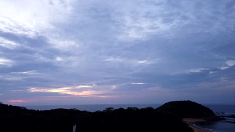 timelapse of a beach, we see the clouds move by sunset