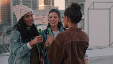 beautiful women friends hugging on rooftop party chatting enjoying weekend gathering having fun drinking alcohol at sunset