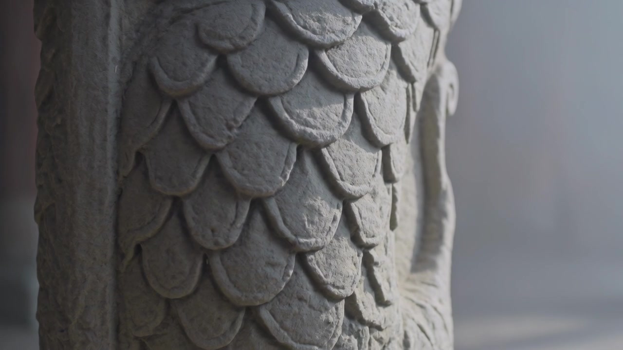 Recording, camera pushing in, shifting right, revealing carved sculpture in studio with rim light