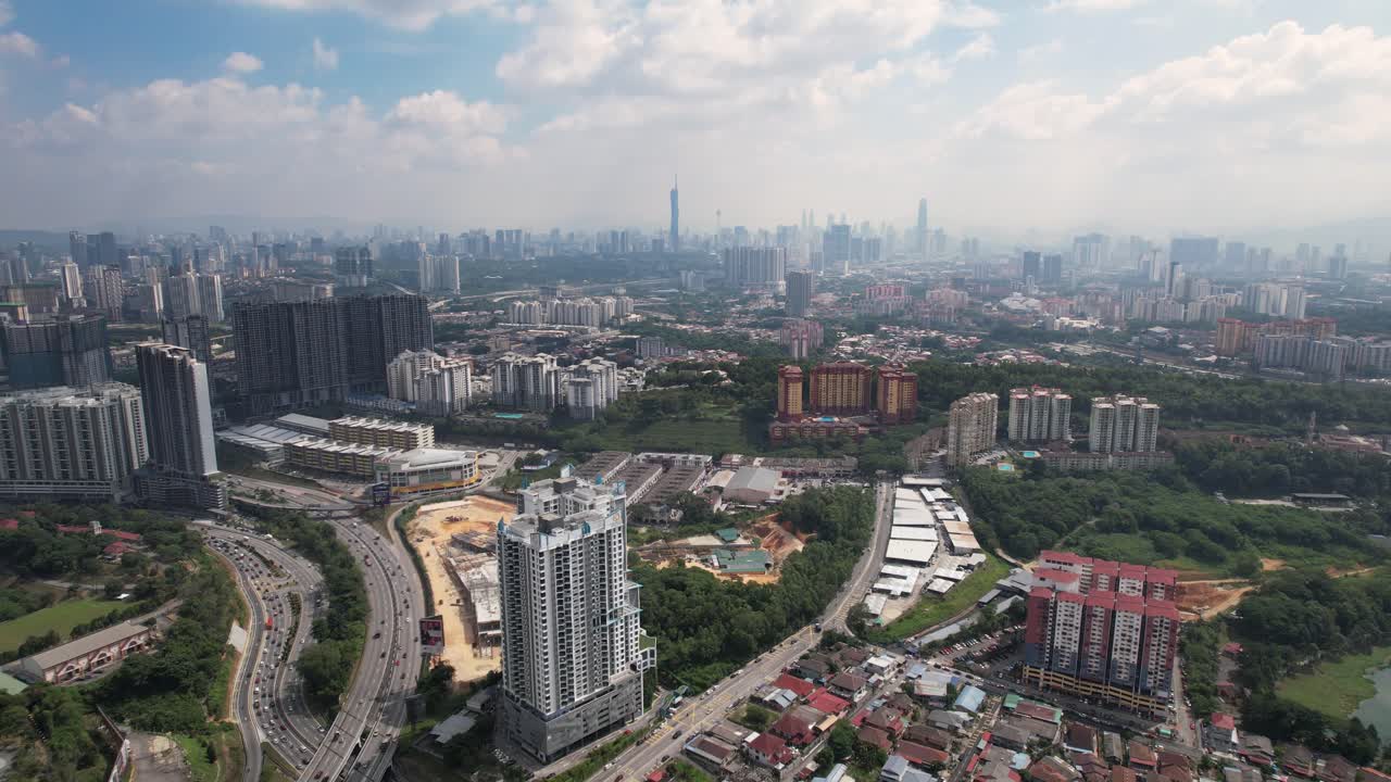 Aerial view of a city with buildings, roads and green areas
