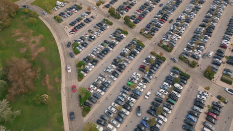 Aerial full town parking near green park. Diverse cars riding at crowded carpark
