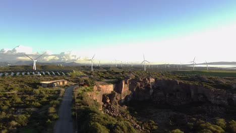 Establisher-aerial-view-of-solar-panels-and-wind-turbines,-sustainability,-day