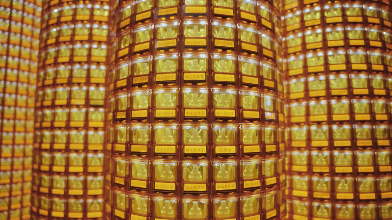 A symmetrical close-up of many towers of golden Buddha statues glowing in illuminated niches at Ciyou Temple in Taiwan, symbolizing devotion, peace, and spiritual reverence in a sacred Buddhist space