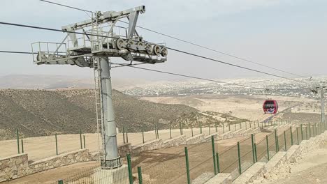 cable car of the aerial tramway connecting oufella peak and agadir city in morocco, overlooking a panoramic view of the beach-4