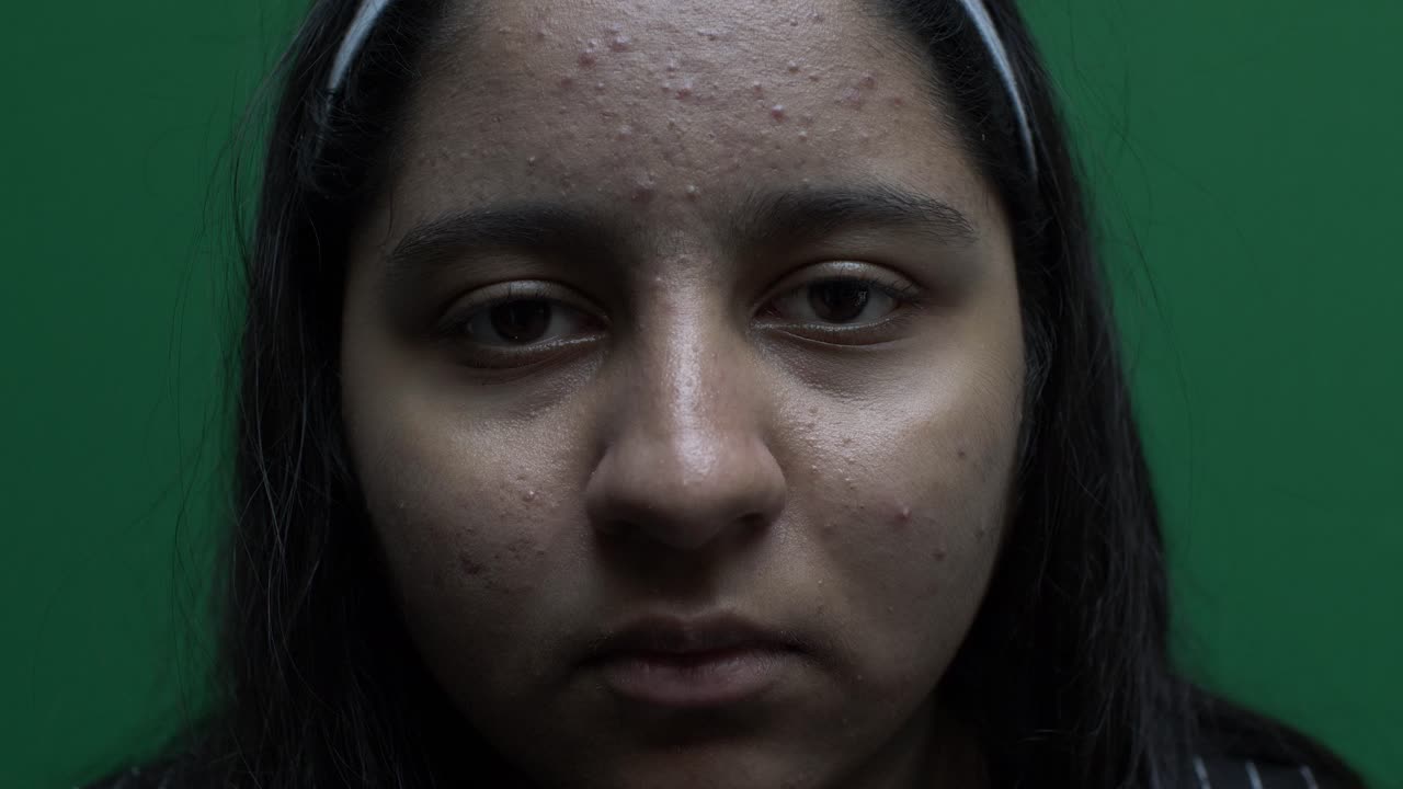 retrato de un joven adolescente asiático del reino unido mirando directamente a la cámara