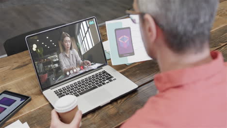hombre de negocios caucásico en una videollamada con una colega caucásica en la pantalla