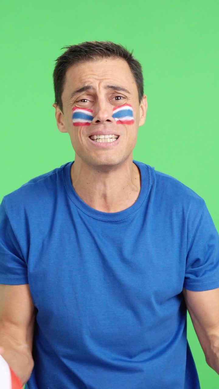 Man cheering for Thailand during a match that is lost