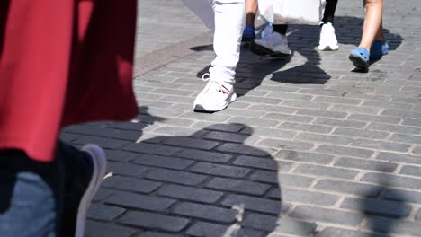 people walking on a cobblestone street