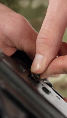 soldier adjusting rifle