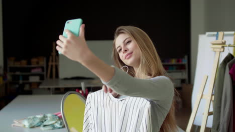 girl holding a dress and taking selfie.