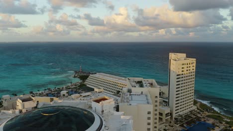 backwards aerial view reveals beachfront hotels